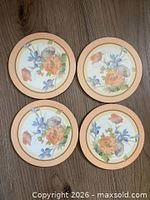 Four floral Pimpernel coasters top view