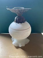 Ceiling light showing frosted embossed globe and metal canopy
