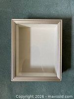 Front view of empty silver shadow box showing frame and interior