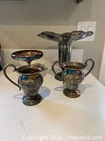Group view of all four silverplate items