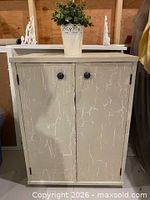 Front view of cabinet showing two doors and knobs