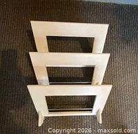 Front view of the three-slot wall magazine rack