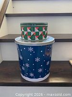 All three tins stacked showing patterns and sizes