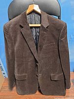 Front view of brown corduroy blazer on hanger