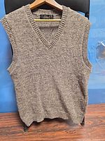 Front view of brown flecked wool vest on hanger