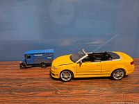 Audi yellow convertible next to blue Marcel Gardet van showing relative sizes