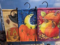 Front view of all three garden flags on display stands