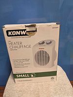 Front of boxed Konwin fan heater showing brand, model illustration, wattage options, small room suitability