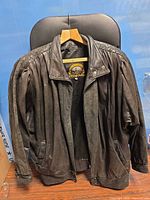 Front view of leather jacket on hanger