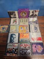 Overall view of 16 CDs laid out on table