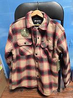 Front view of Matix plaid shacket on hanger showing plaid pattern and pockets