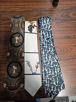 Front view of three cartoon novelty neckties