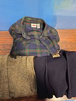 Three sweaters laid out showing overall appearance and colors