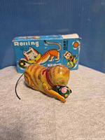 Tin cat toy with original box visible
