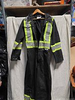 Front view of black coverall with reflective tape