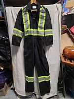 Front view of black coveralls with lime reflective striping