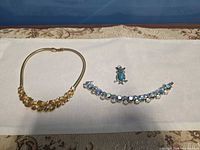 Overview of necklace, bracelet and pendant laid out