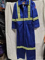 Front view of full-length royal blue coverall with reflective striping