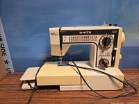 Front view of White Jeans mechanical sewing machine with cords