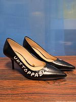 Side view of both shoes highlighting graphic text and heel style