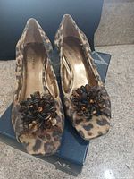 Top view of both Anne Klein leopard wedge sandals displaying flower embellishments and overall condition