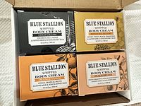 Top view of all four boxed body creams inside shipping carton