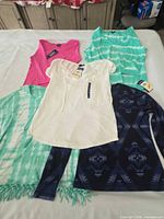 Five Chaps women's tops laid out showing colors, patterns and tags