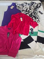 All five tops laid out showing tags and colors