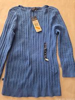 Front view of Chaps blue cable knit sweater with tags attached