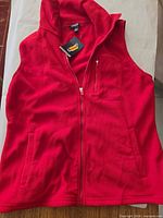 Front view of red Chaps fleece vest with tag attached