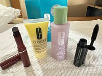 Full set showing moisturizer tube, clarifying lotion bottle, mascara, lipstick, and Clinique box
