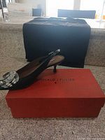 Slingback shoe on branded box, showing style, color, heel and pattern
