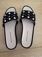 Top view of both slide sandals showing polka-dot uppers and beige insoles