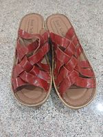 Top view of both sandals showing red leather straps, footbeds and soles