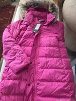 Front view of hot pink Lands' End puffer coat showing hood with faux fur, tags attached