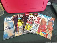 Group shot of five visible magazines in the lot