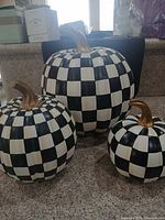 Front view of all three checkered resin pumpkins
