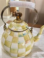 Side view of MacKenzie-Childs checkerboard teapot showing pattern, handle, spout, and glass knob