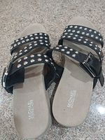 Top view showing overall design, color, stud embellishments and brand logo on footbed