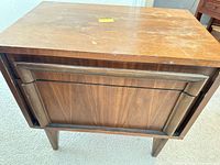 Front view of nightstand showing drawer design, surface scratches, water stains