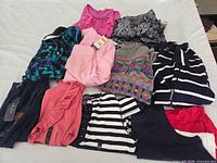 Group shot of all ten garments arranged on table