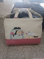 Front view of Radley London tote showing dog appliqué, colour blocking, handles and shoulder strap