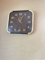 Front view of Sunshine square wall clock showing dial and trim
