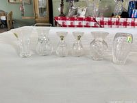 Six Waterford crystal miniature vases lined up on table