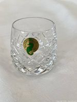 Close view of a Waterford Patterns of Sea crystal shot glass with sticker showing cut-glass pattern and clarity