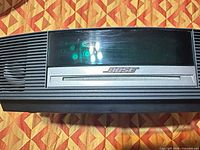 Front view of Bose Wave Music System showing display, CD slot, brand logo