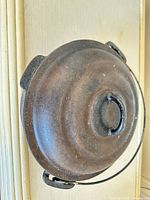 Top view of Dutch oven showing domed lid, loop handle, bail handle