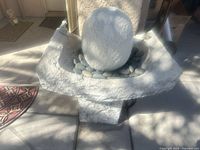 Full view of fountain showing basin, sphere and rocks