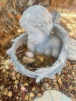 Angel planter showing overall form, material and condition
