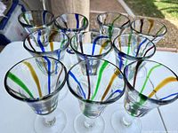 Front angled view of 10 multicolor swirl wine glasses on table